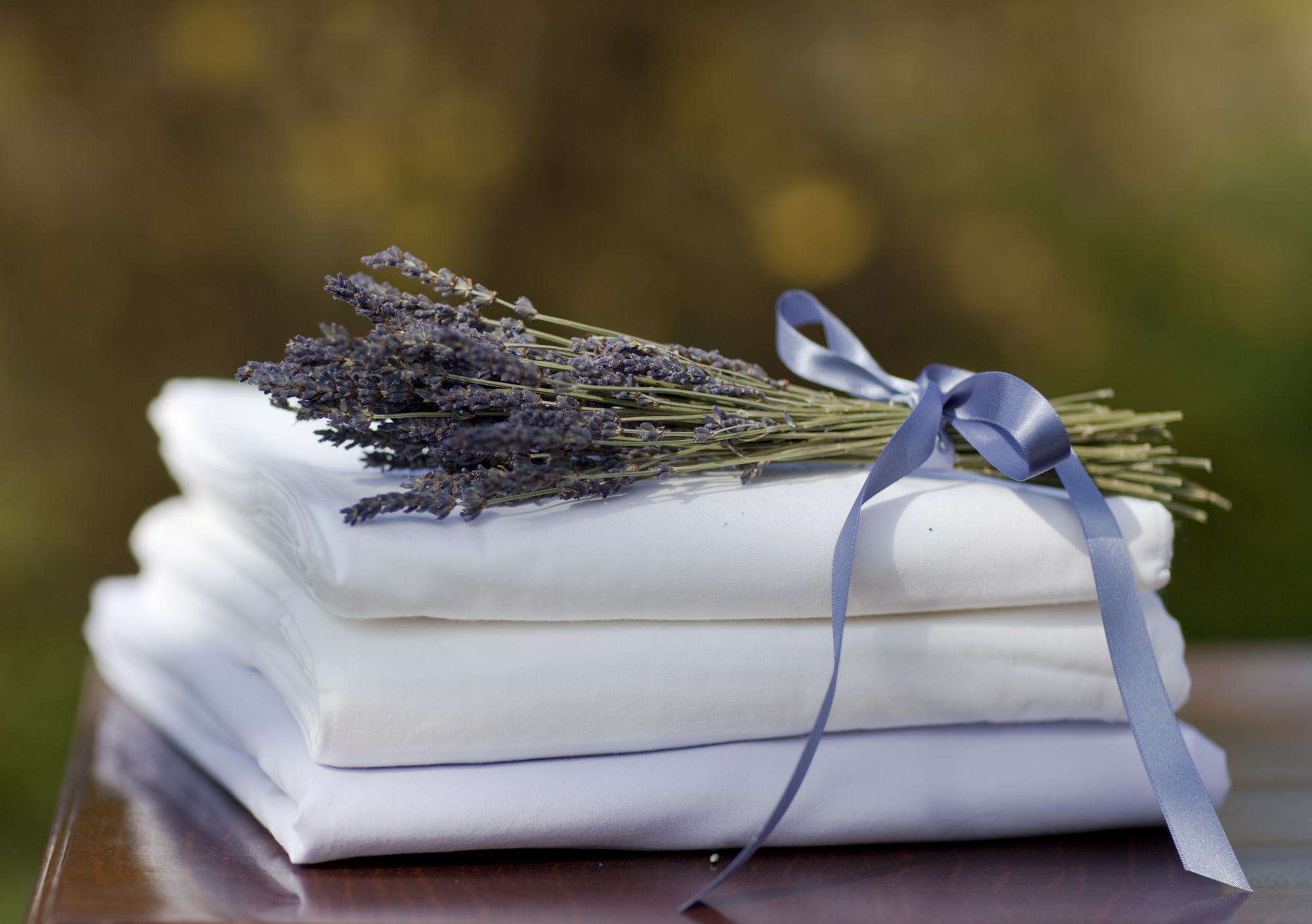 Freshly ironed sheets with a sprig of lavender